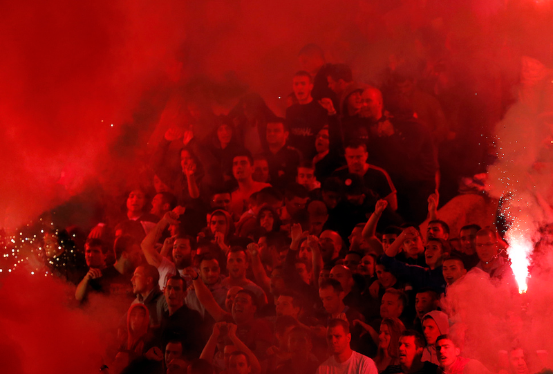 Illustration for article titled Smoke, Flares, Riot Police In Belgrade Derby Make For Haunting Photos